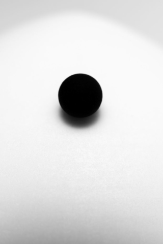 A black sphere on a white dome, gradually rolling down. At a glance, they seem perfect abstractions, but closer inspection reveals the rough texture and imperfection of real objects, actually existing.